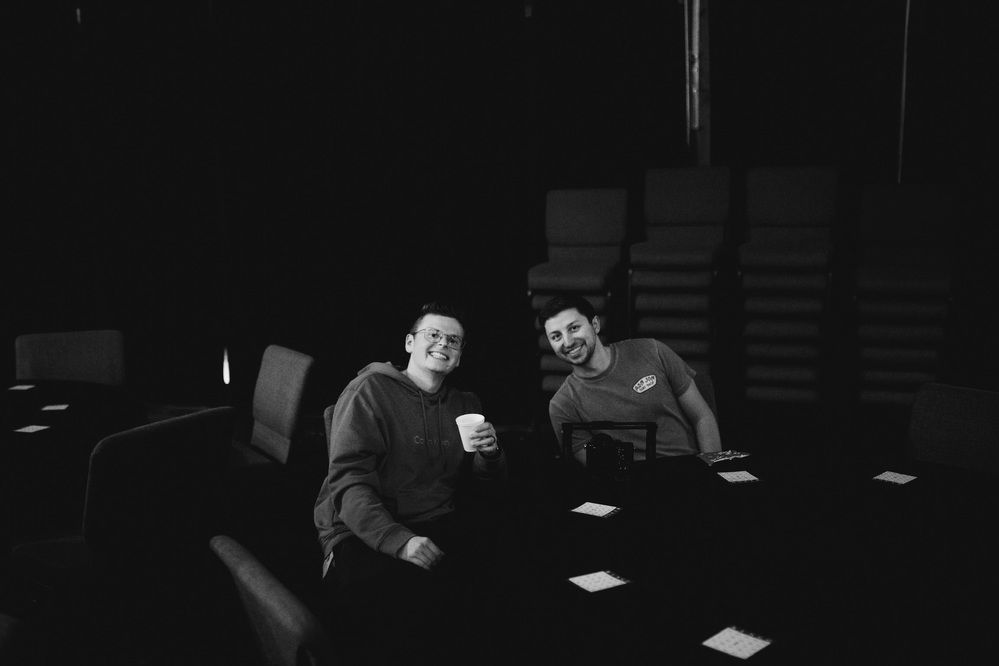 Two friends smiling at a table