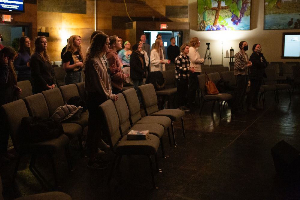 Young adults standing together in worship