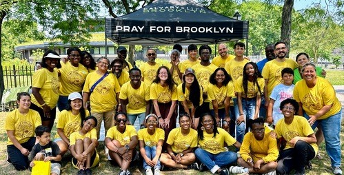 Volunteers and kids at Brooklyn Vacation Bible School smiling together