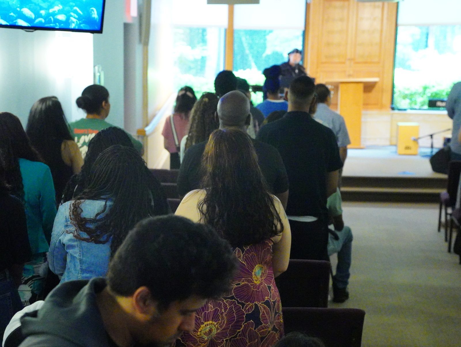 The congregation at Calvary Life Brooklyn with heads bowed during a service