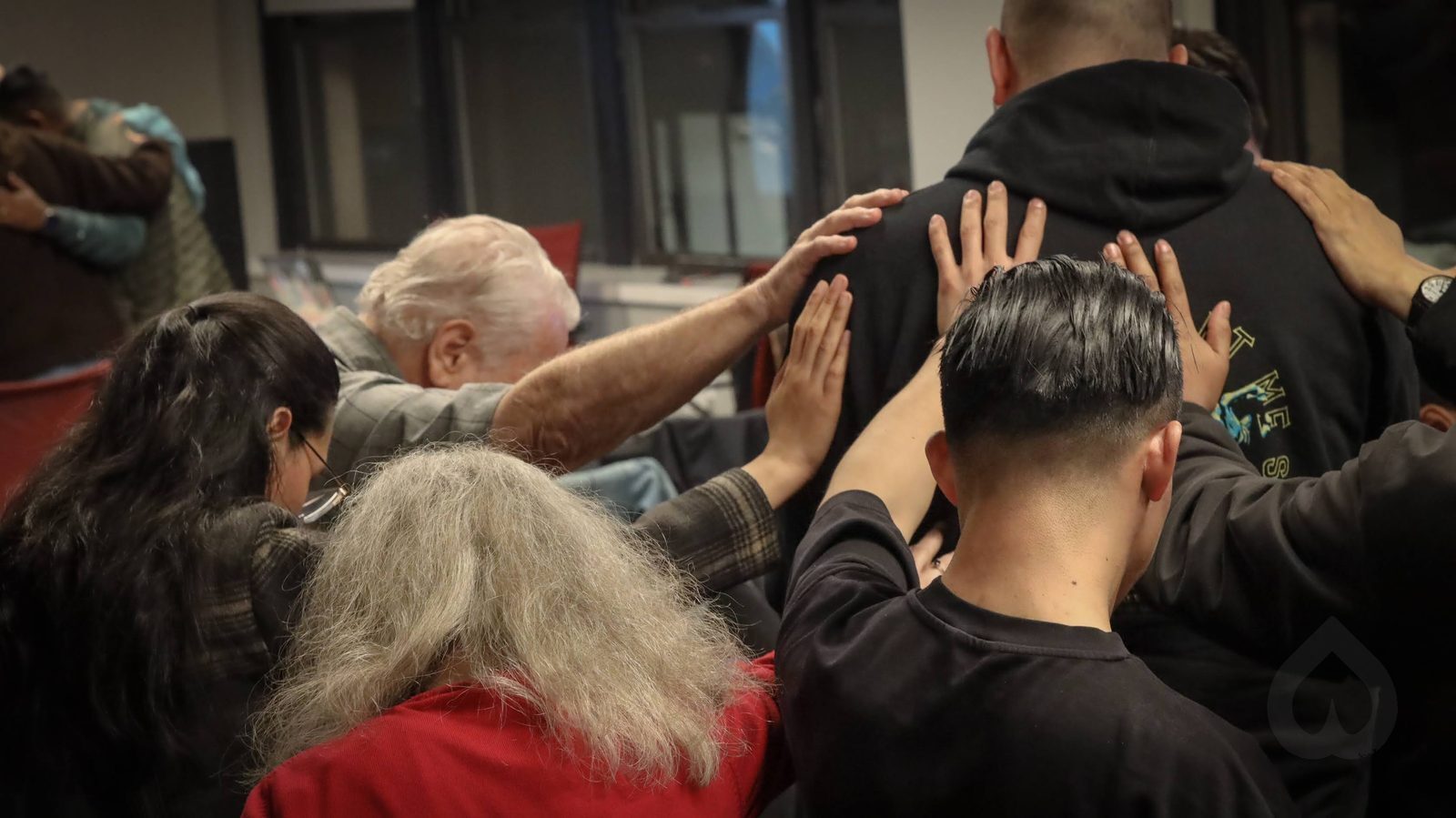 Members of Calvary Life Brooklyn laying hands on one another in prayer