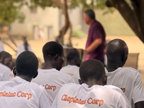 Chaplains Corps students in South Sudan listening to outdoor Bible teaching