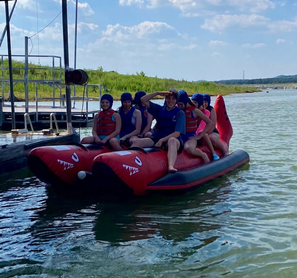 Students tubing on the lake at camp