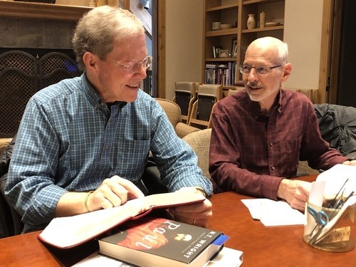 Two participants in men's Bible study discussing a passage