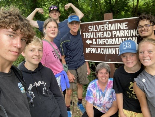 Group of youth and advisors at trailhead on youth mission trip