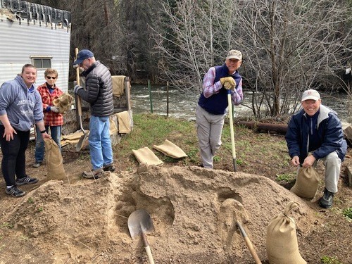 Filling sandbags to protect against flooding