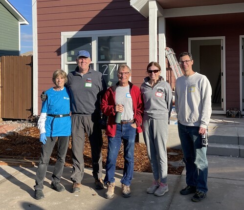 Five volunteers at a Habitat for Humanity Build Day