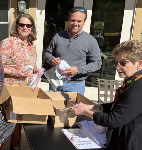 Three congregants packing disaster hygiene kits