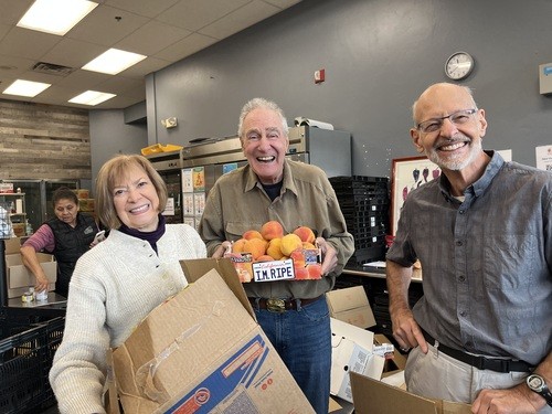 Three volunteers at the Community Market in Edwards
