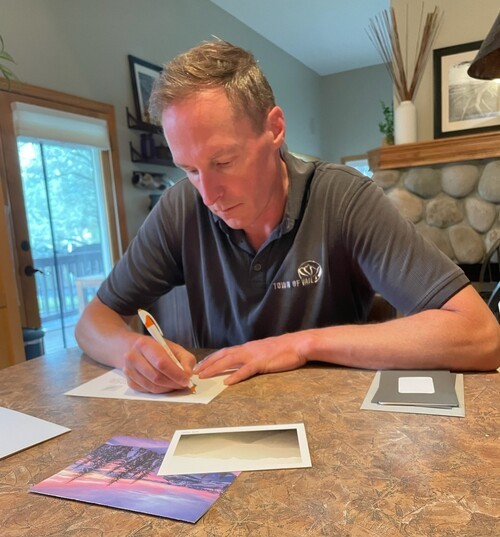 A Deacon writing cards