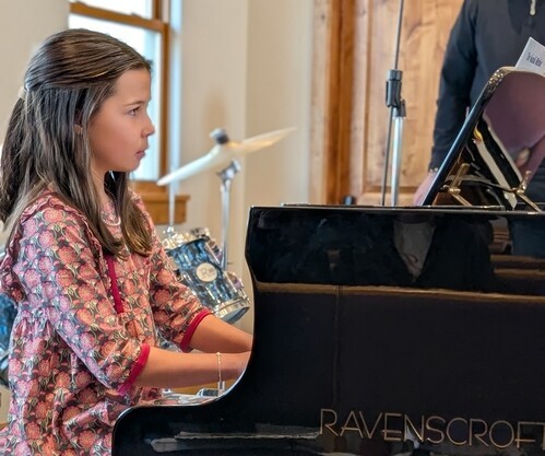 Young girl playing piano solo