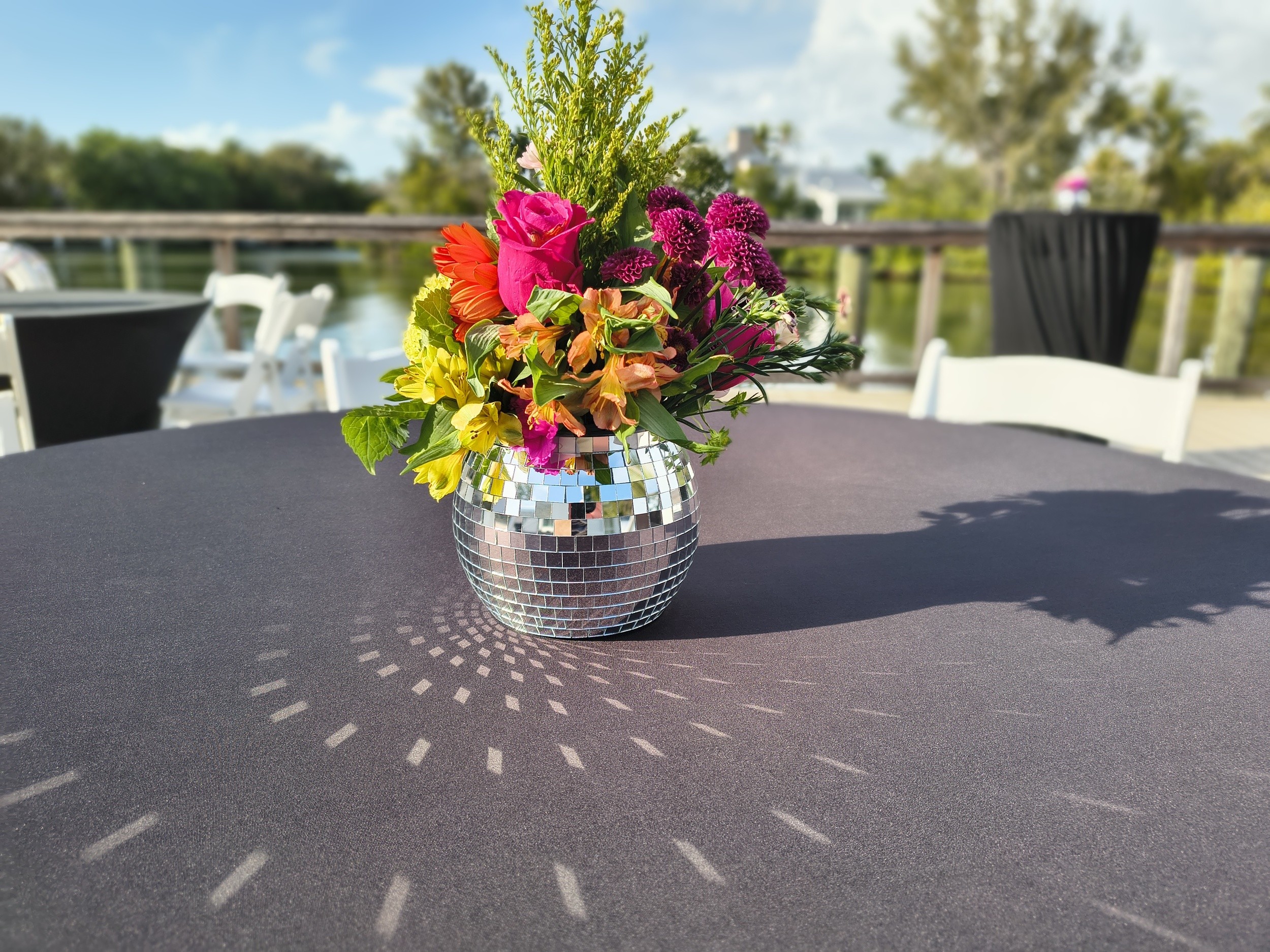 The Art of Giving floral centerpiece overlooking the waterfront