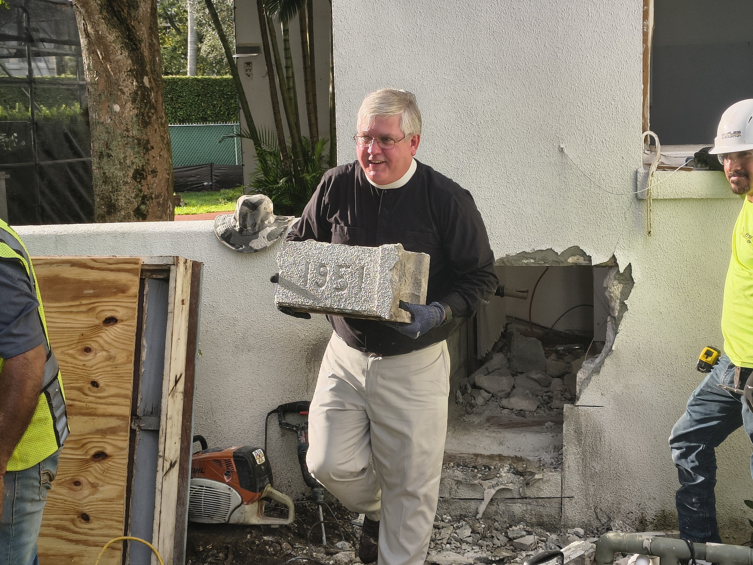 The cornerstone being carefully removed from Trinity-by-the-Cove