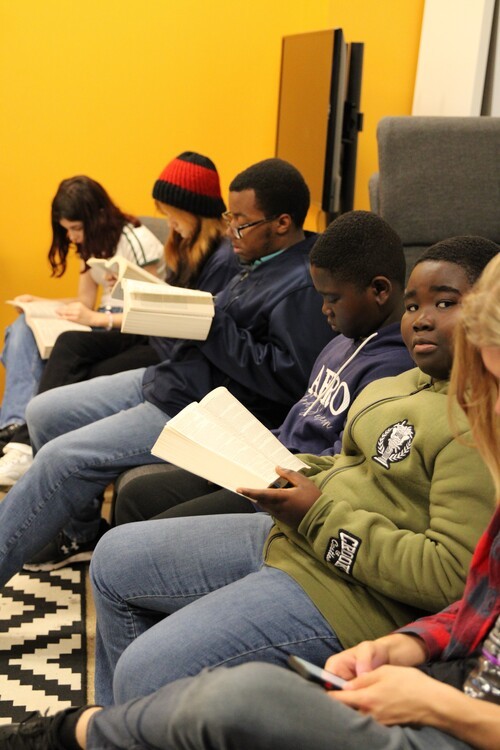 A group of people reading the bible together for bible study