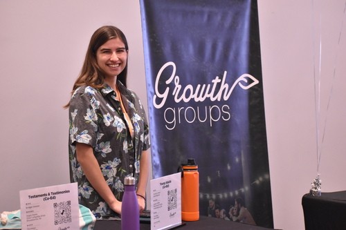 Young adult helping others join groups at Crossroads