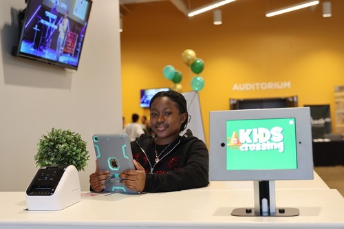 One of our great team members helping children check in to kids crossing