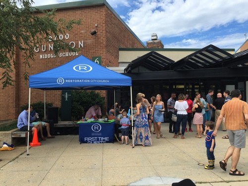 Restoration City Church welcome tent and guests gathered outside Gunston Middle School before Sunday service in Arlington, VA.