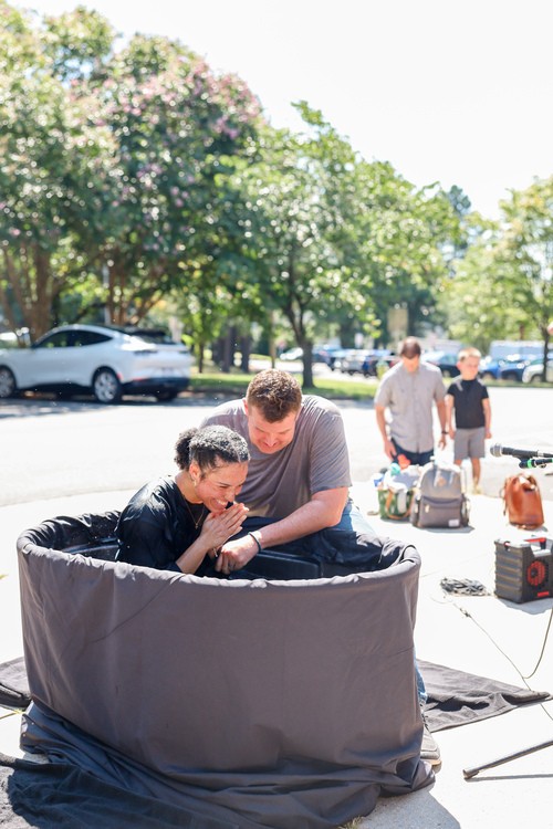 Young children reading picture books together on the floor during kids ministry at Restoration City Church.