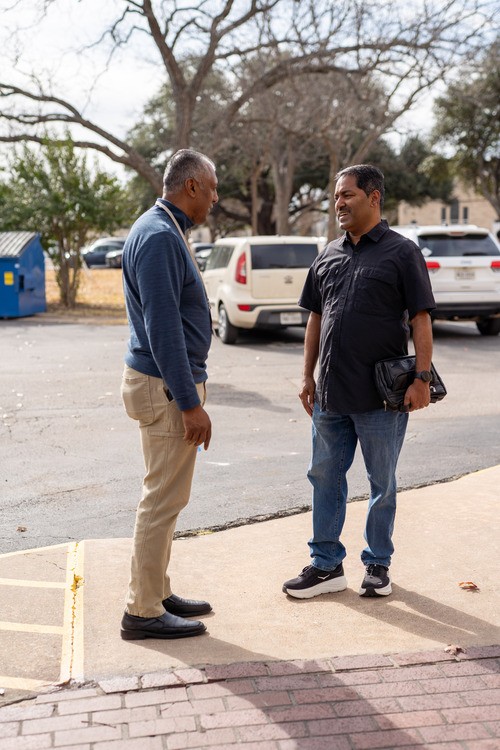 Two men talking in the parking lot outside Awaken Church, a non-denominational church in Round Rock, TX