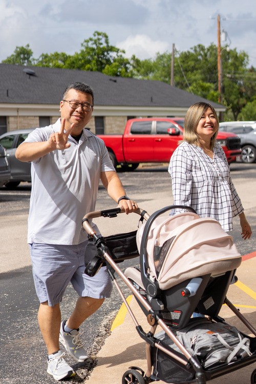 Family with baby stroller outside Awaken Church, a non-denominational church in Round Rock, TX
