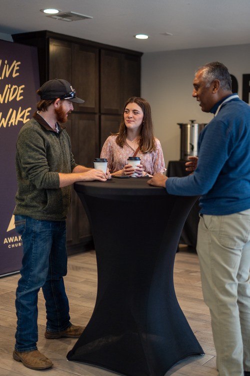 Serve Team members connecting over coffee at Awaken Church in Round Rock, TX