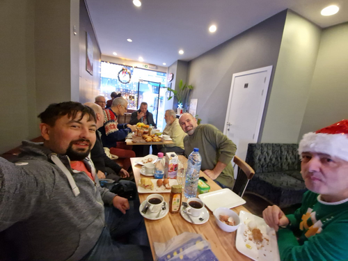 Right side: Shop owner (in hat), Ivan to his right