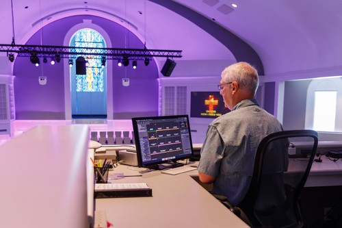 Man using computer in church sanctuary