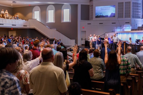 Congregation worshipping with raised hands