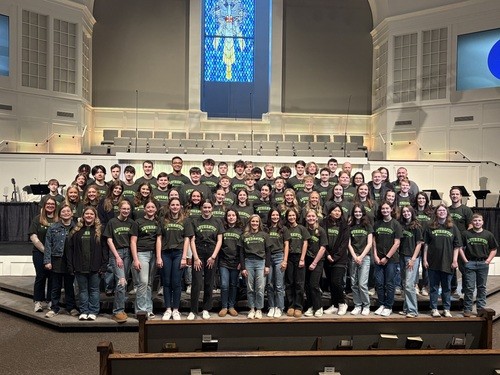 teenage boy with a hammer smiling