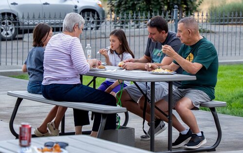 Families eating together at picnic tables outside Westridge Church