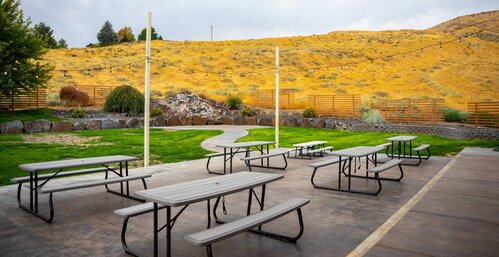 Tables set up on the church grounds with the hills behind