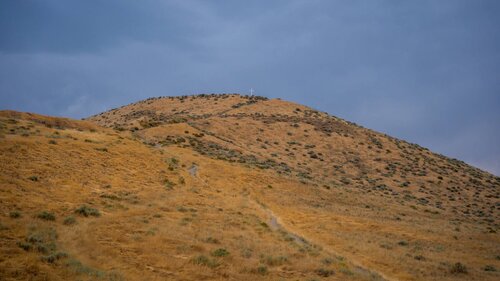Flat Top Hill behind the church, with the cross on the ridge
