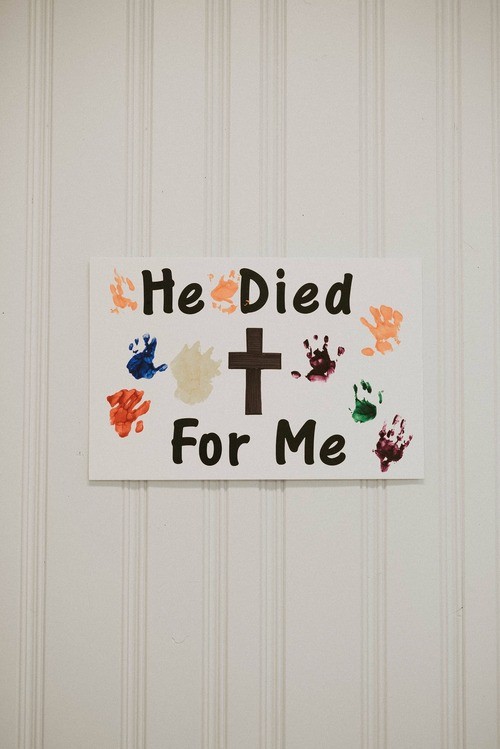 Child's finger painting on a wall with the words 