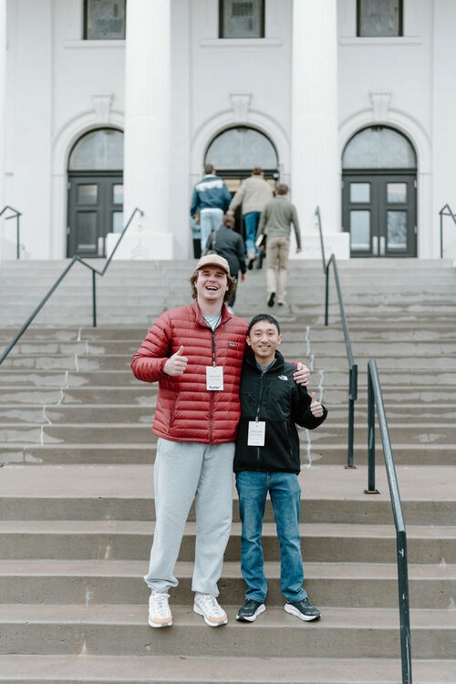 Two raised hands in worship, one in front of the other