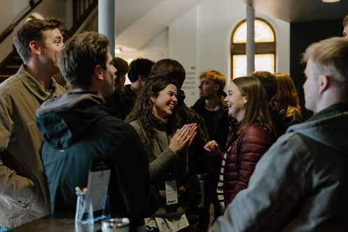 An elderly woman hugging a younger woman of color