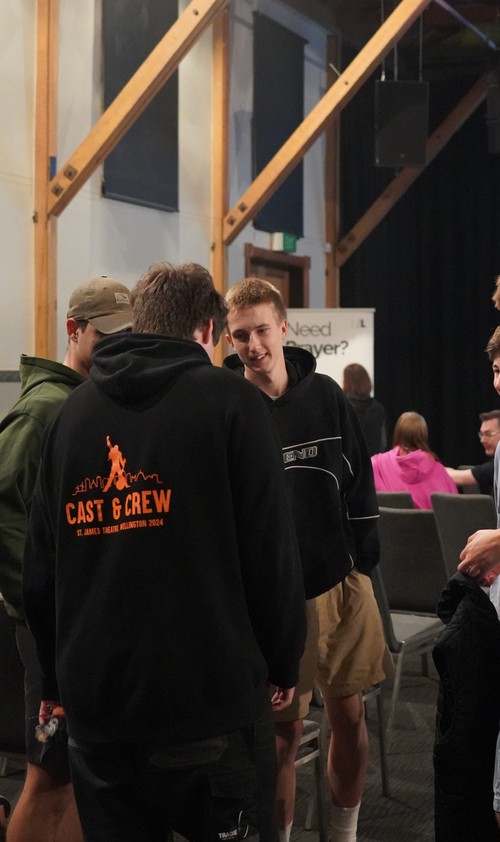 Young adults talking and connecting during a church group gathering.