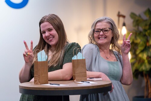 Two women holding peace signs