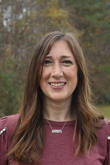 photo of man with trees in the background