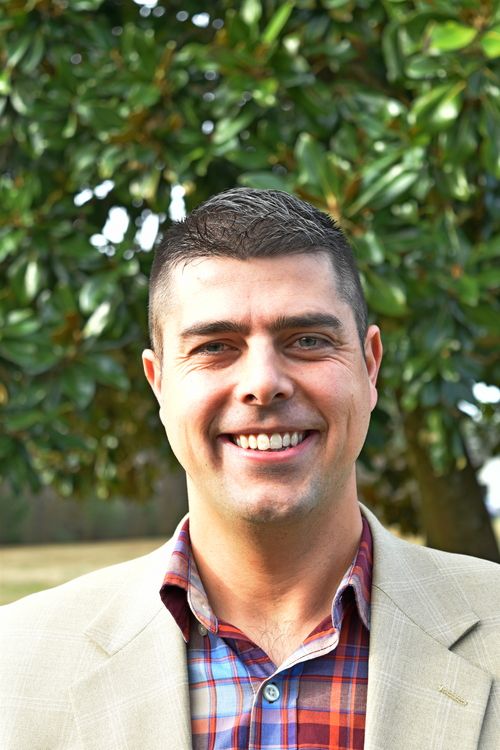 pastor Jacob headshot photo with trees in background