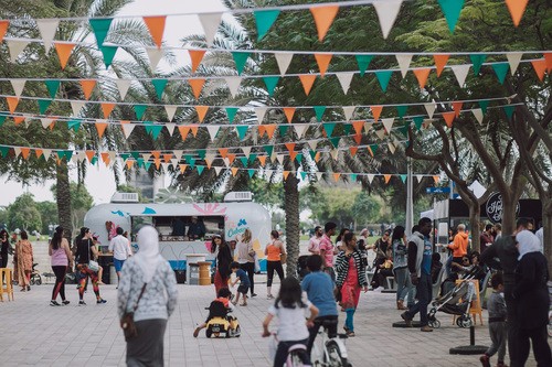 a crowd in a city park