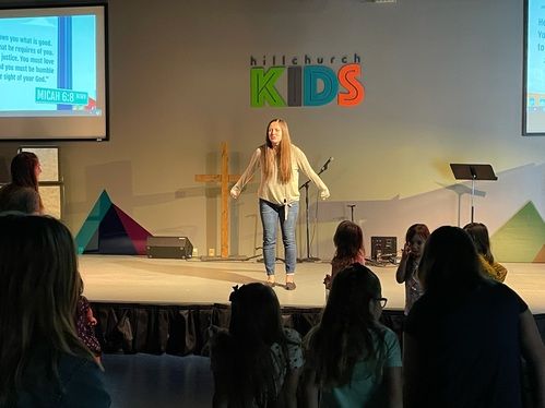 Pastor teaching Children engaging in Sunday school activities at Church on the Hill.