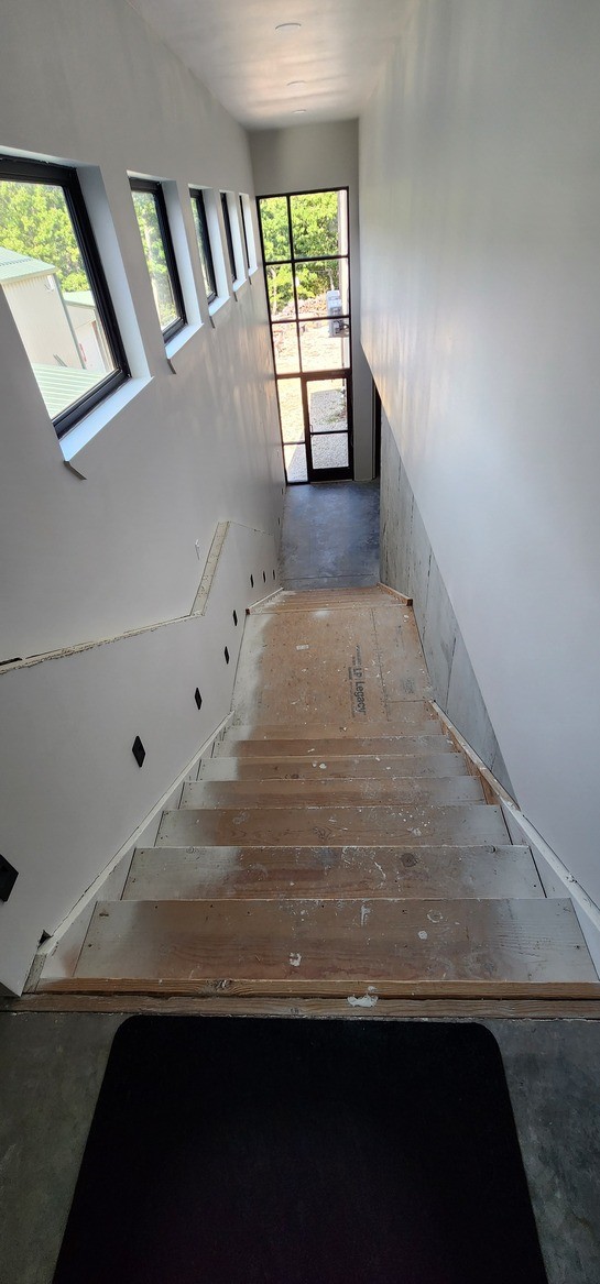 Main stairwell leading to the lower level of the new addition