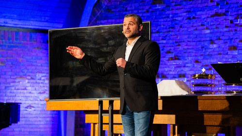 Pastor Andrew Farhat preaching in the worship center