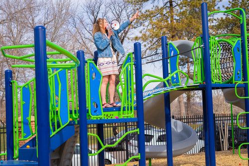 Children's Church director Kadie speaking by megaphone on the playground