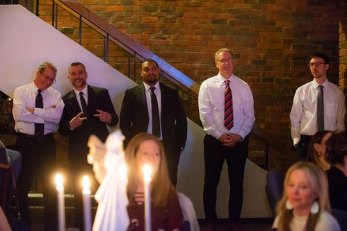 Men dressed formally in a line in the worship center