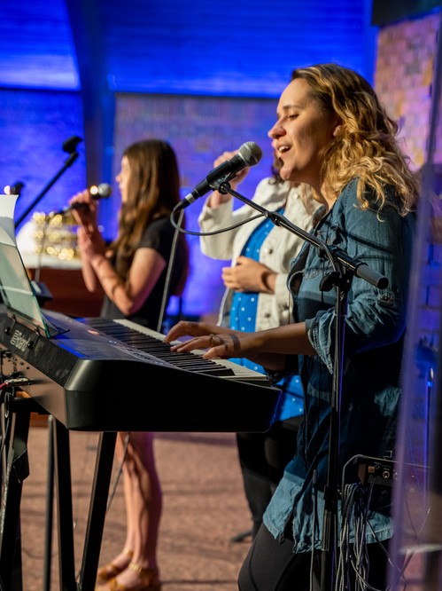 Band members singing in the Worship Center