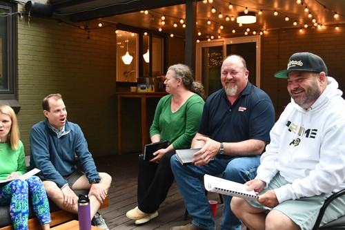 Group of people having a Bible study outside 