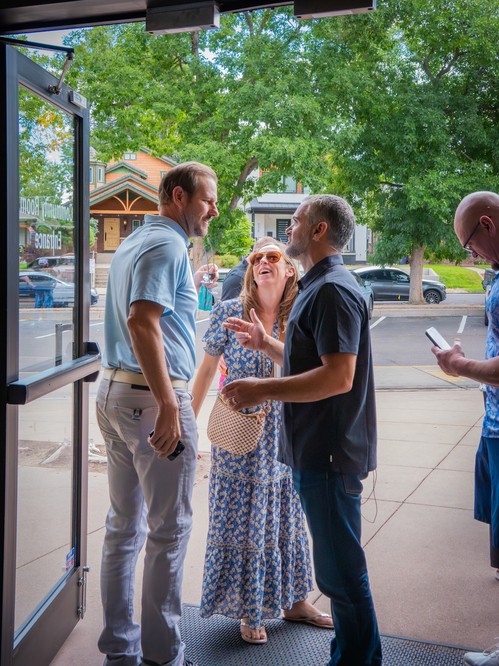 People talking to Pastor Andrew Farhat outside after a worship service