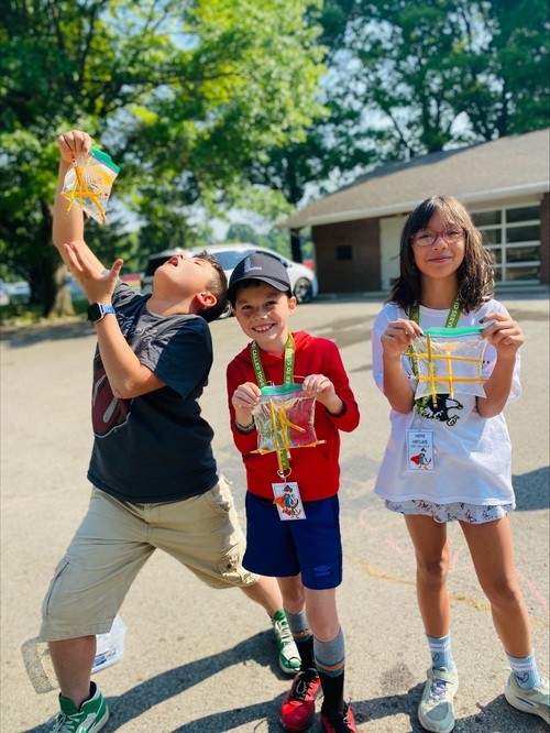 Children showing off arts and crafts
