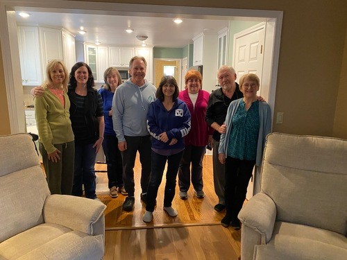 Picture of 8 men and women in the home of the Grow Group Leaders.